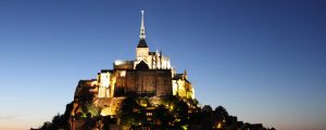 Illuminated Mont Saint-Michel at dusk.