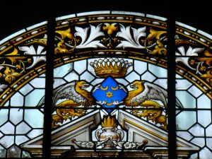 Stained glass with crown and eagle design.