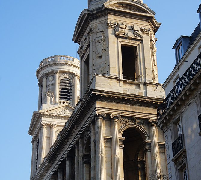 A very tall building with two large towers.