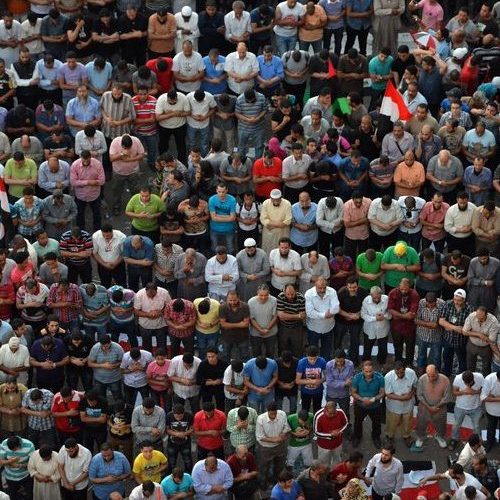 A large group of people standing in the middle of a crowd.