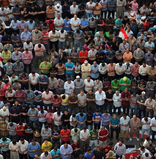 A large group of people standing in the middle of a crowd.