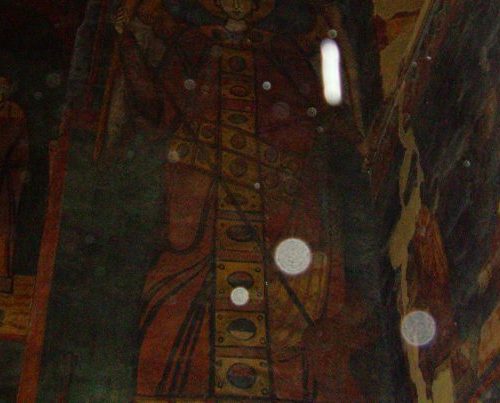 A painting of jesus is reflected in the mirror.