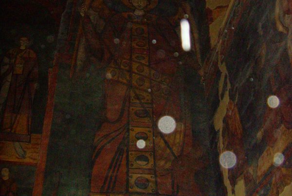 A painting of jesus is reflected in the mirror.