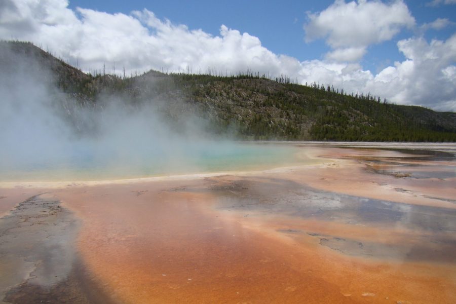 A hot spring with steam coming out of it.