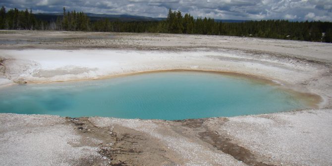 A blue pool of water in the middle of an area.