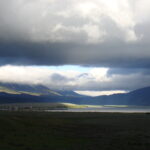 A large open field with mountains in the background