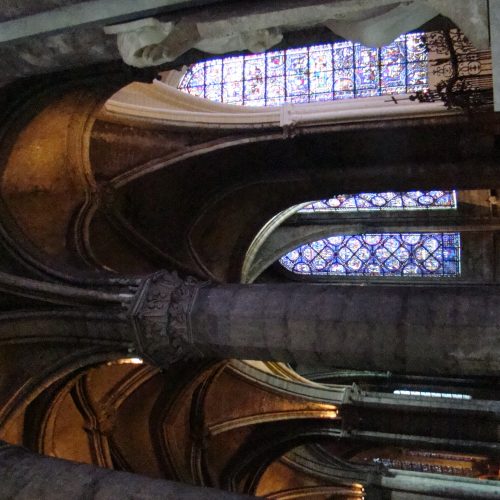 A cathedral with stained glass windows and pillars.