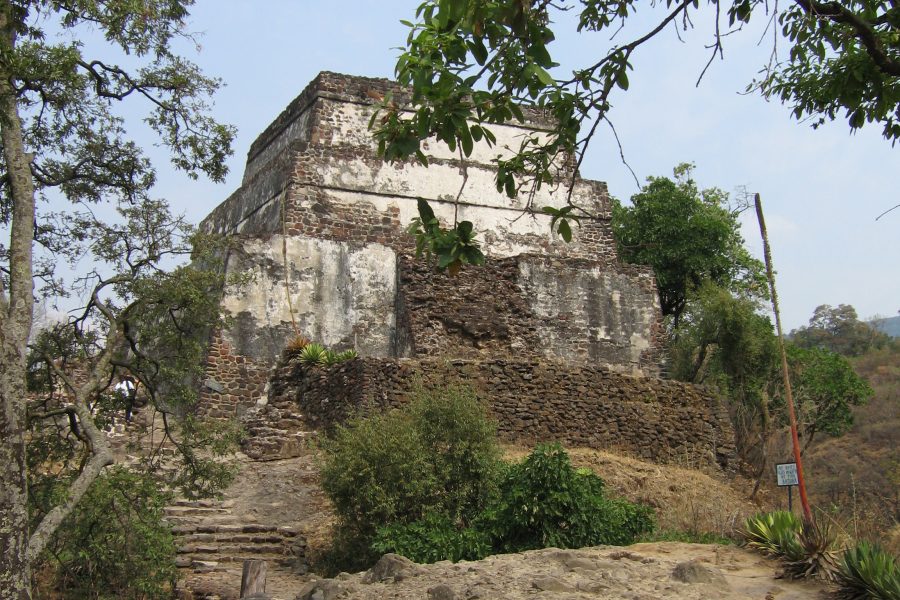 A building on top of a hill with trees around it.