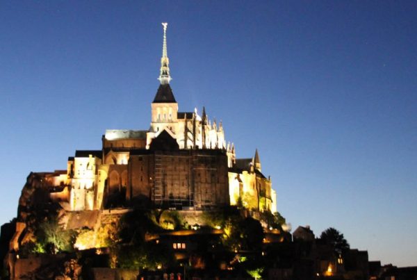 A castle like building with a spire on top of it.