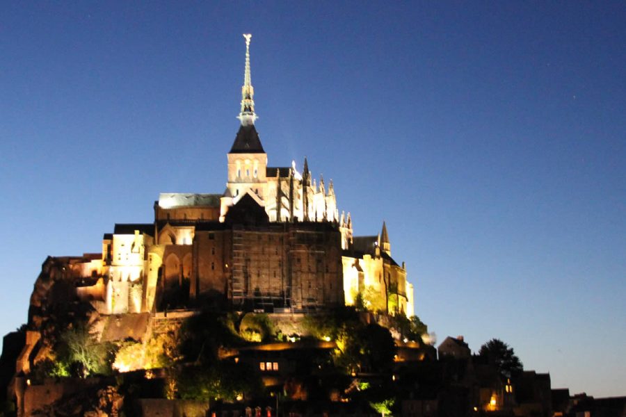 A castle like building with a spire on top of it.