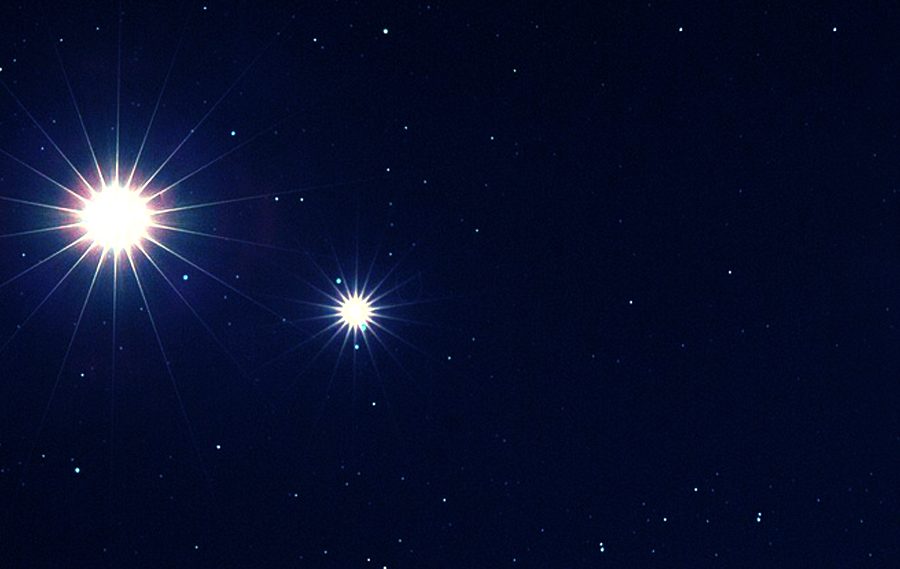 A bright star shines in the night sky.