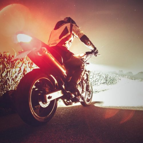 A person riding on the back of a motorcycle.