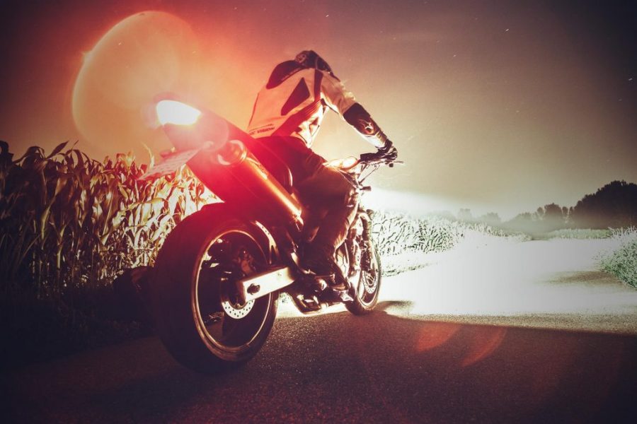 A person riding on the back of a motorcycle.