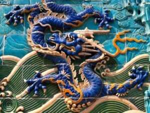 Blue dragon relief on decorative wall.