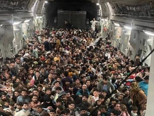 A large group of people are gathered together in an airport.