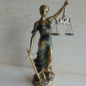 A statue of lady justice holding the scales.