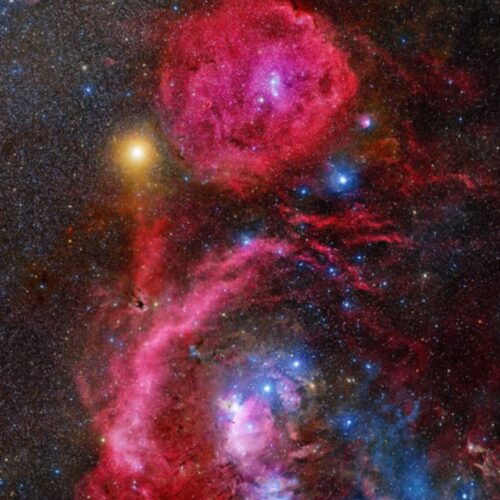 A red nebula with stars and nebulae in the background.