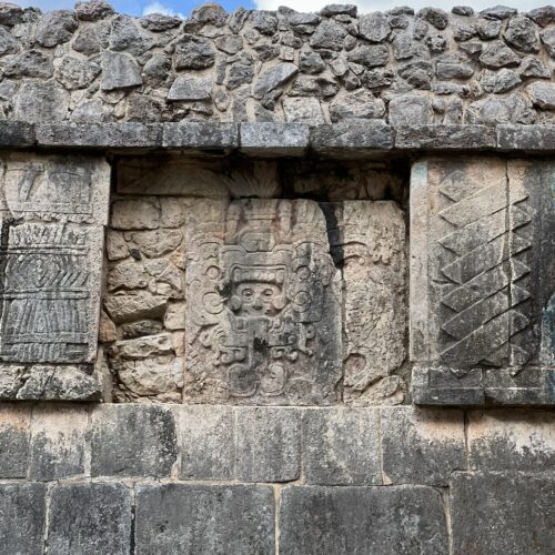 A stone wall with carvings on it.