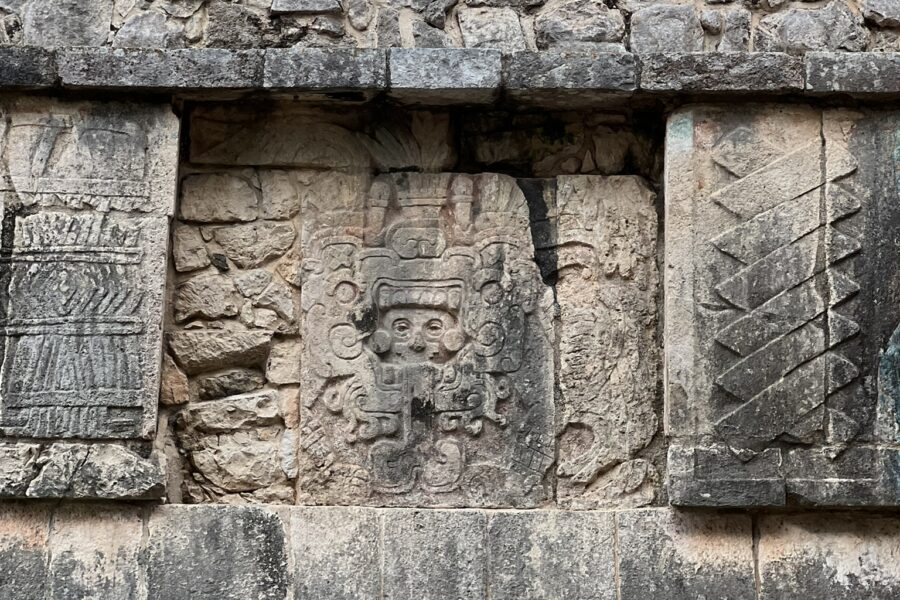 A stone wall with carvings on it.