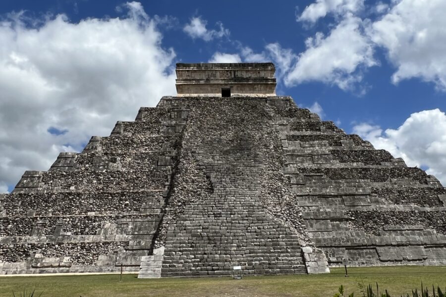 A large stone structure in the middle of a field.