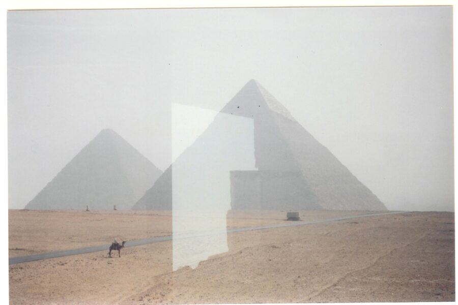 A picture of the pyramids in egypt with a glass window.