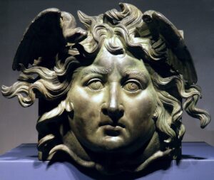 A statue of medusa head with long hair.